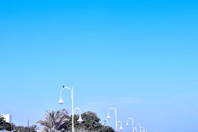 Low angle view of street light against clear blue sky