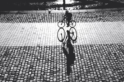 Shadow of woman on footpath