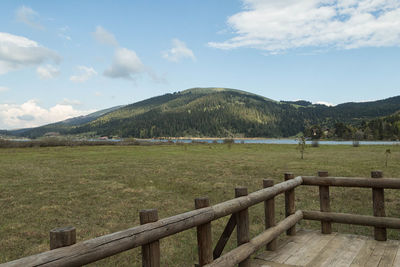 Scenic view of field against cloudy sky