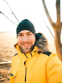 Portrait of smiling man in park during winter