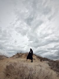 Full length of man standing on road against sky