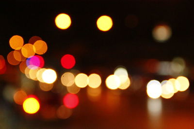 Defocused image of illuminated street lights at night