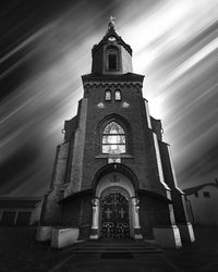 Low angle view of church and building against sky