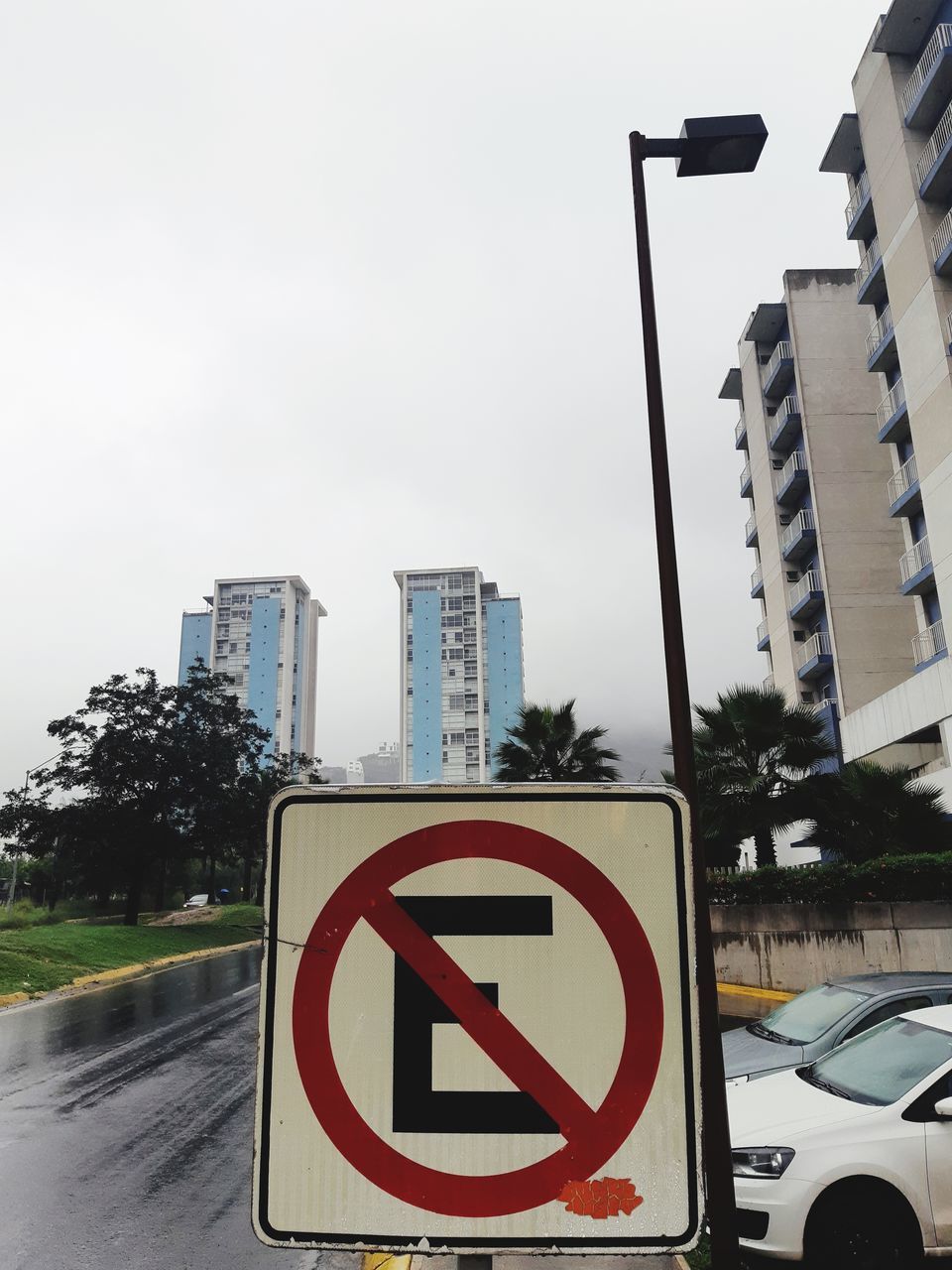 sign, road, communication, road sign, city, building exterior, architecture, built structure, transportation, car, sky, warning sign, motor vehicle, no people, guidance, mode of transportation, information, nature, information sign, day, outdoors, office building exterior, skyscraper