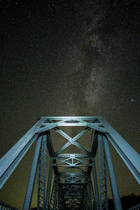 Low angle view of bridge against sky at night