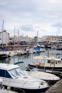 View on the harbor of saint-martin-de-ré with boats and people walking on a sunny summerday