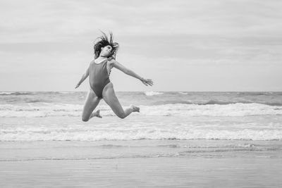 A girl jumping in the beach