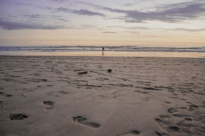 Scenic view of beach against sky during sunset