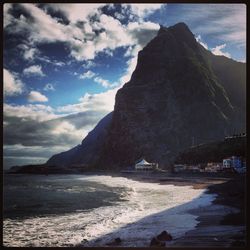 View of beach against cloudy sky