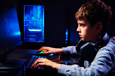 Boy plays computer game at home, gaming addiction