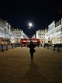 Man walking in city at night