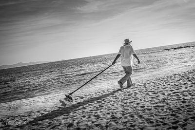 Man standing on beach against sky