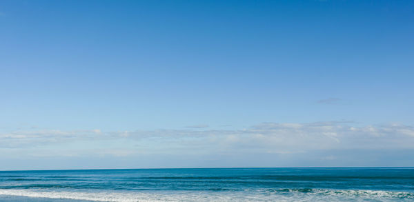 Scenic view of sea against blue sky