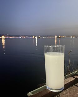 Glass of water on table against sky