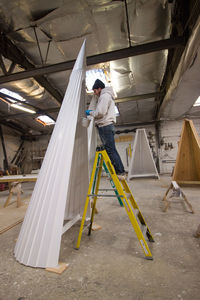 Full length of man working in shopping mall