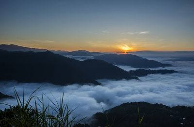 Scenic view of silhouette mountains against sky during sunset