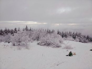 Scenic view of snow covered land against sky
