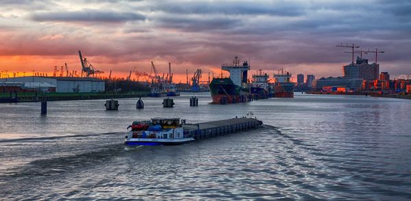 Nautical vessel on sea against sky during sunset