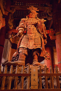 Low angle view of statue against temple