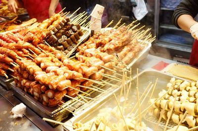 Person preparing food on display at market