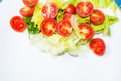 High angle view of chopped tomatoes over white background