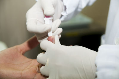 Cropped image of doctor examining patient in hospital