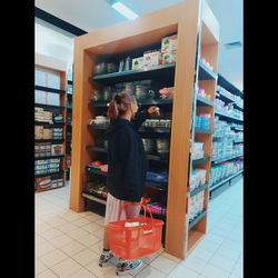 Rear view of woman standing in store