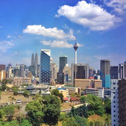 View of cityscape against cloudy sky