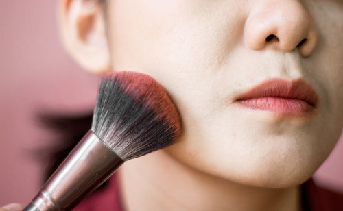 Cropped image of woman applying make-up