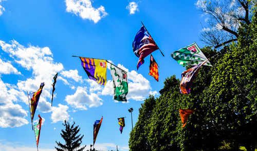 Low angle view of flags against sky