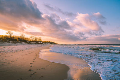 Scenic view of beach against sky during sunset