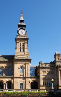 Low angle view of clock tower against sky