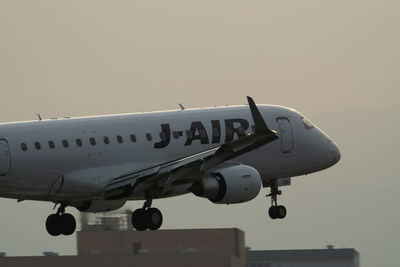 Low angle view of airplane against clear sky