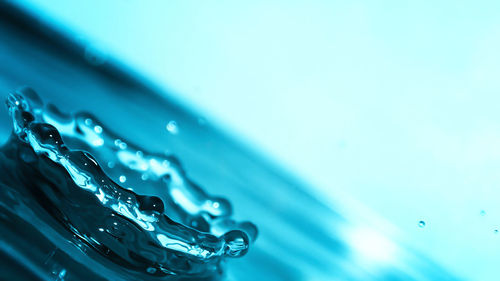 Close-up of water drops against blue background