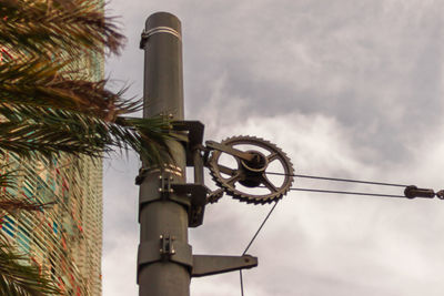 Low angle view of telephone pole against sky