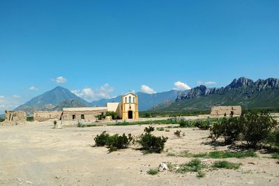 Church on landscape against mountain range