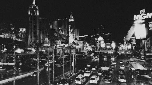 Aerial view of illuminated buildings in city at night