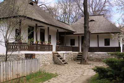 Exterior of traditional romanian house by building against sky