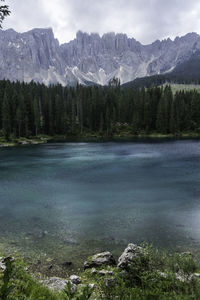 Scenic view of lake by mountains against sky