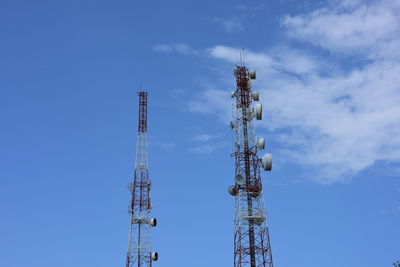 Low angle view of communications tower against blue sky