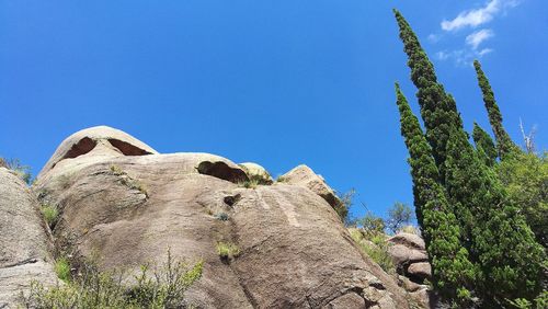 Low angle view of fresh green mountains against clear blue sky