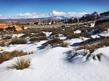 Scenic view of snow covered land against sky