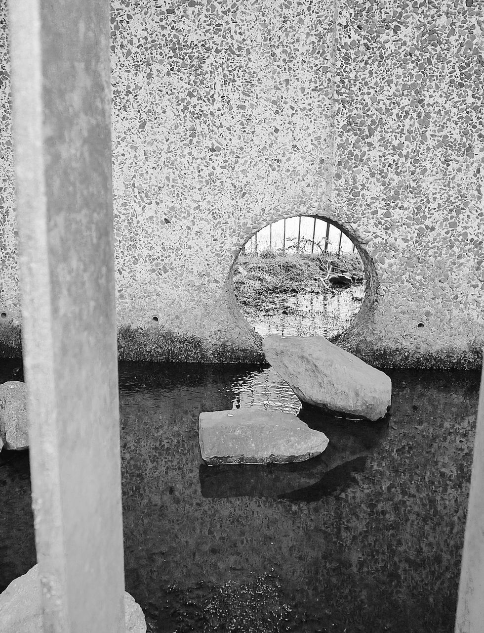 CLOSE-UP OF WATER WITH REFLECTION OF BUILT STRUCTURES