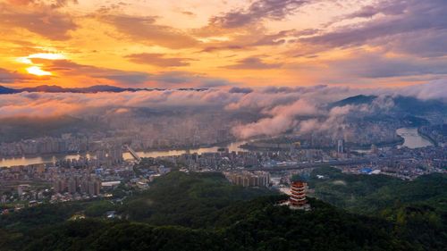 High angle view of buildings against sky during sunset