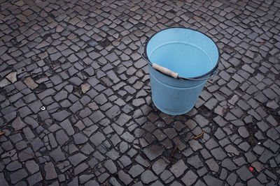 High angle view of bucket on cobblestone street