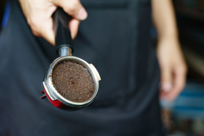 Close-up of hand holding coffee cup