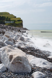 Rocks on beach against sky