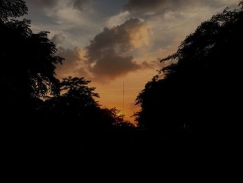 Silhouette trees against sky at sunset