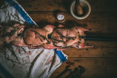 Directly above shot of marinated duck spit on table