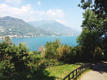 Scenic view of river and mountains against sky